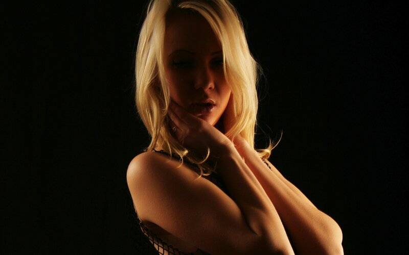 woman in black lace against dark background