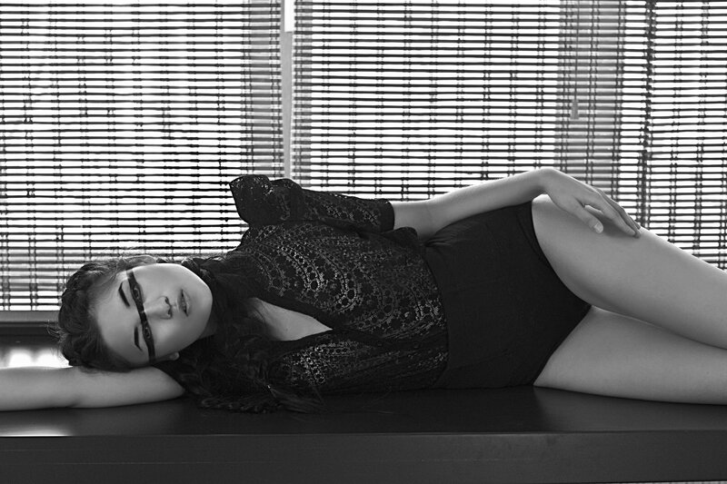woman in black lace lying down
