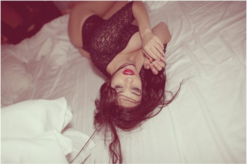 woman in black lace lying on bed