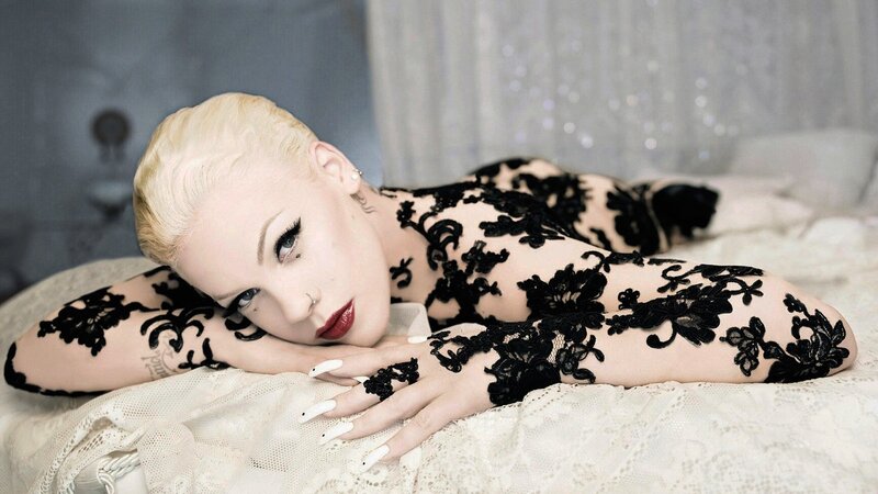 woman in black lace lying on bed