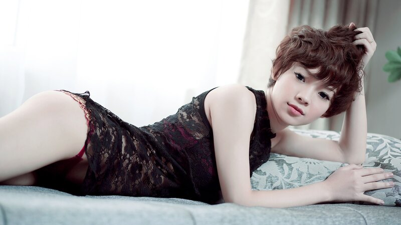 woman in black lace lying on bed