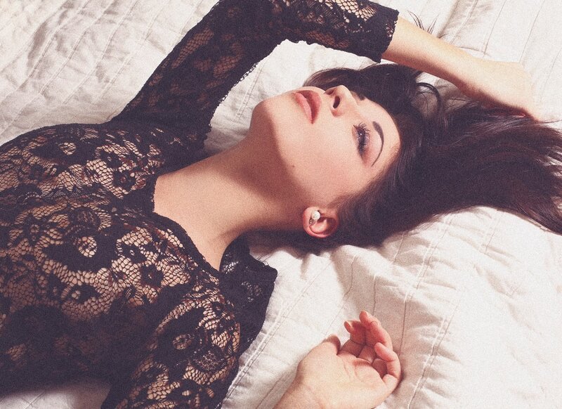 woman in black lace lying on bed