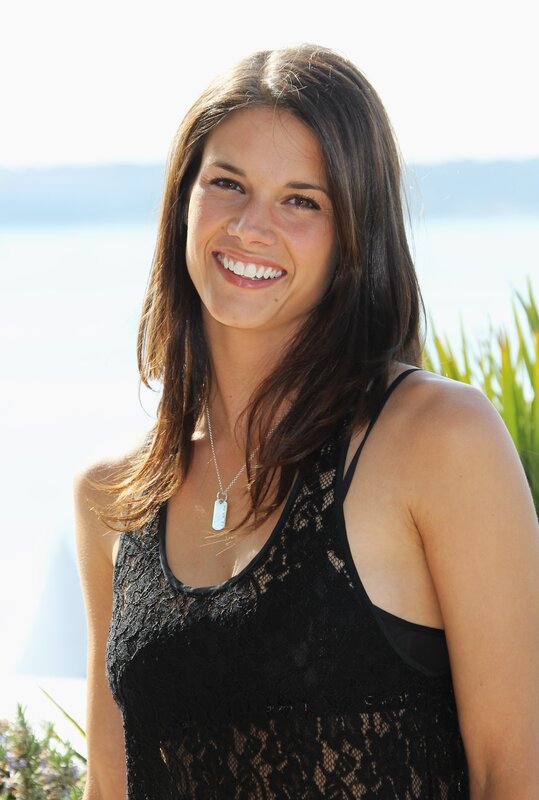 woman in black lace top smiling