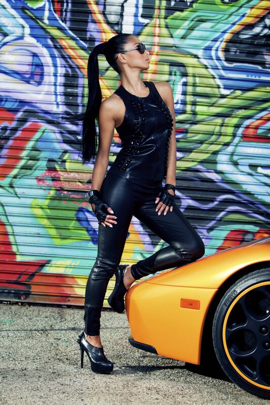 woman in black leather by car