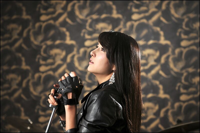 woman in black leather holding microphone