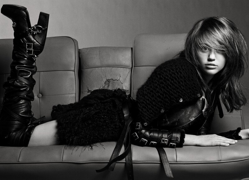 Woman in black leather on couch