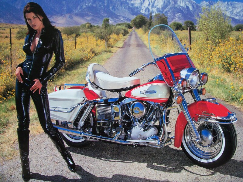 Woman in black leather with motorcycle