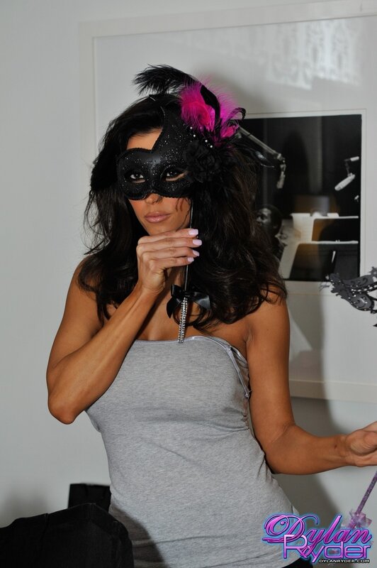Woman in black mask with feathers