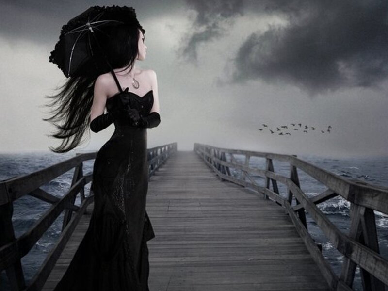 Woman in black on a pier