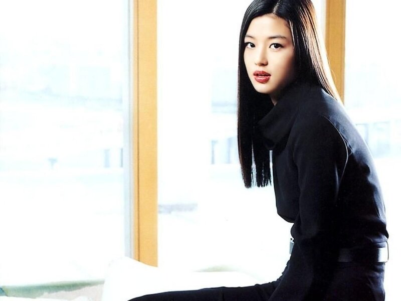 woman in black outfit by window