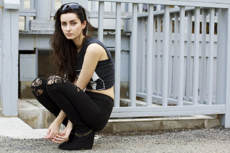 woman in black outfit crouching