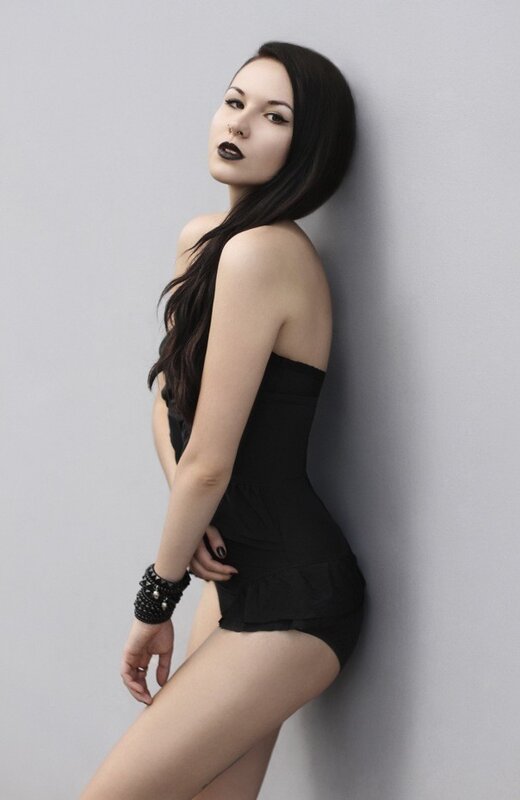woman in black outfit leaning