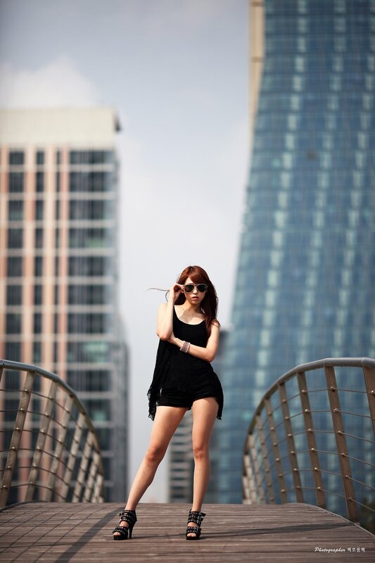 Woman in black outfit on bridge
