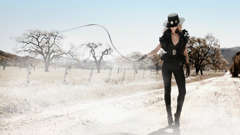 Woman in black outfit on dirt road