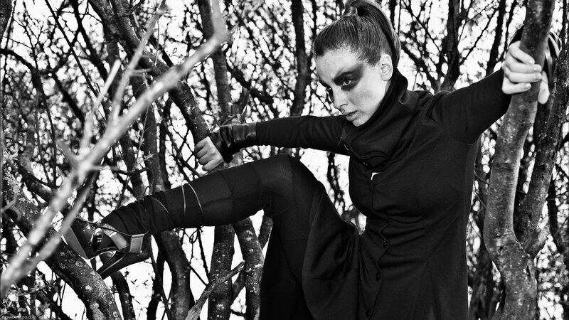 woman in black outfit on tree