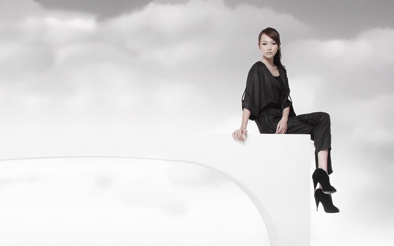 woman in black outfit on white platform