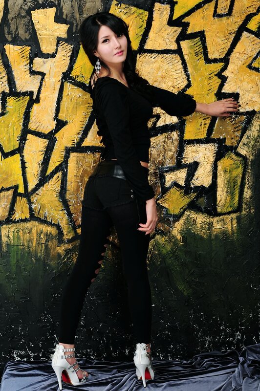 woman in black outfit posing