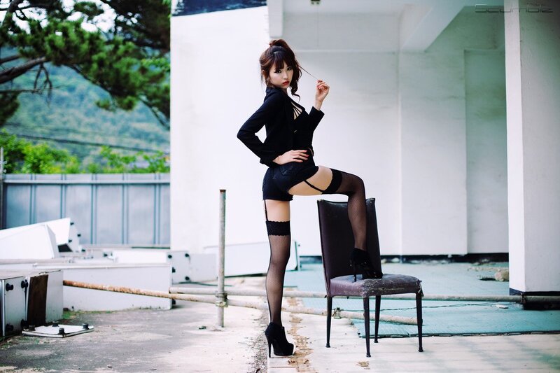 woman in black outfit posing