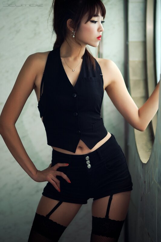 woman in black outfit posing