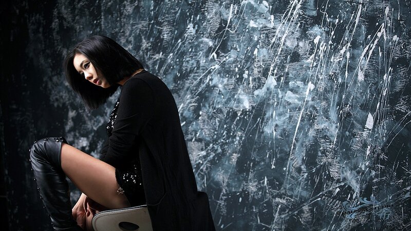 woman in black outfit posing