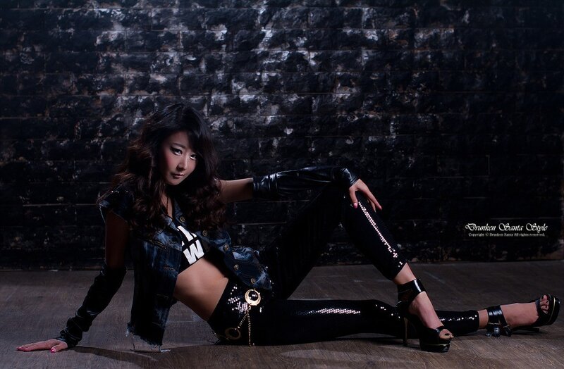 woman in black outfit posing on floor