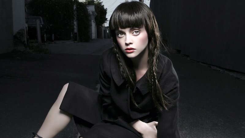 woman in black outfit sitting