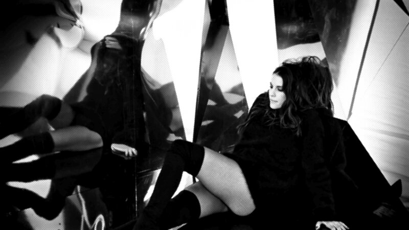 woman in black outfit sitting