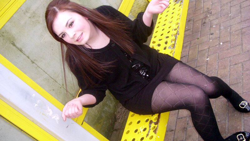 woman in black outfit sitting