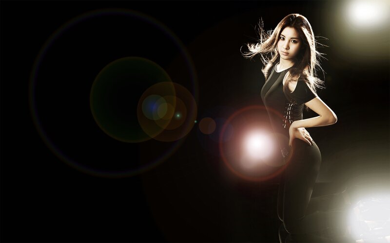woman in black outfit with lens flares