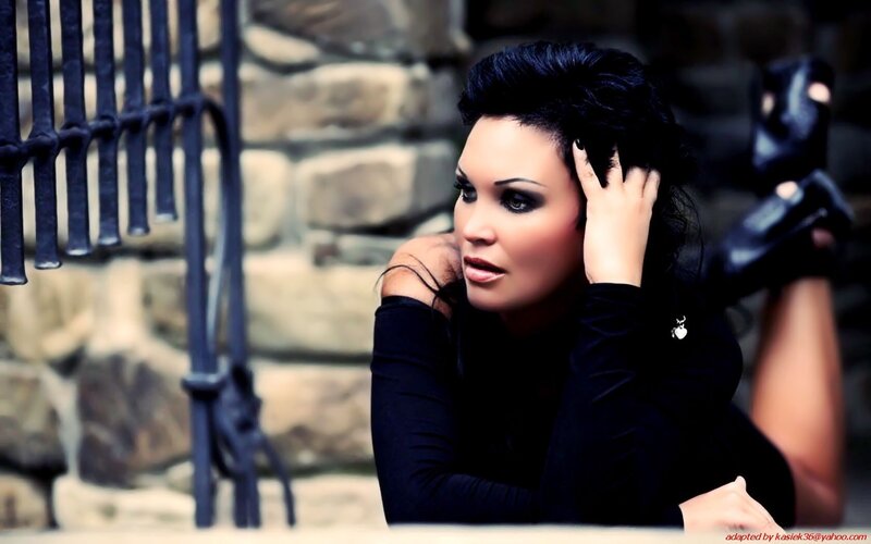 woman in black posing outdoors