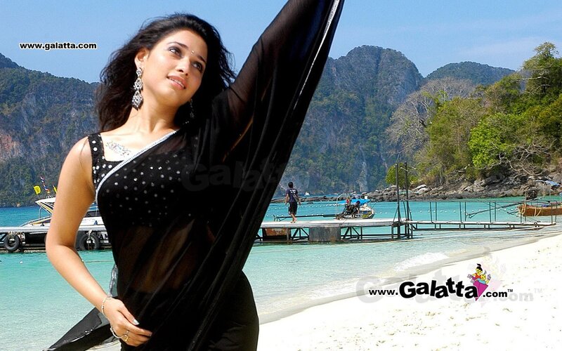 woman in black sari on beach