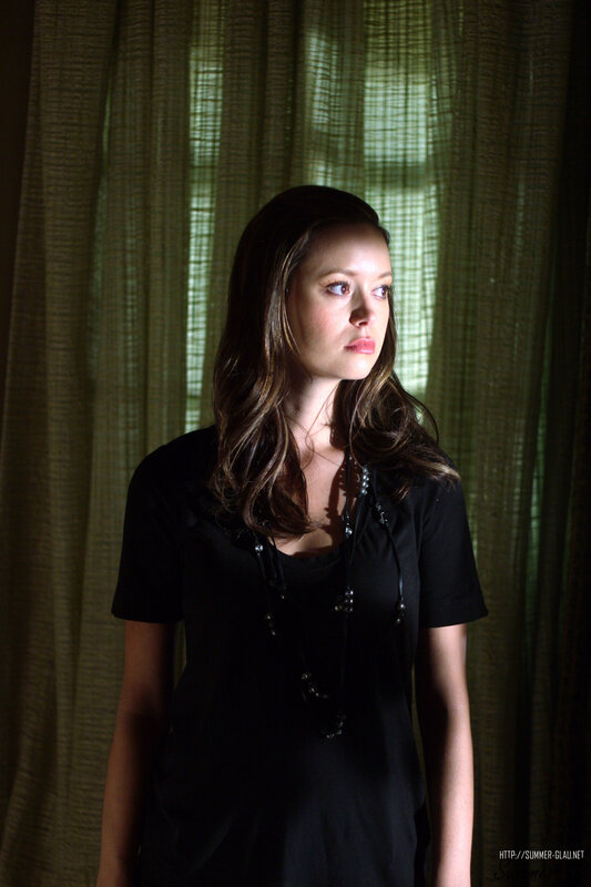 woman in black shirt by window