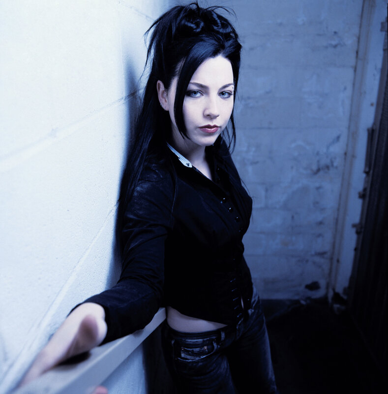woman in black shirt leaning against wall