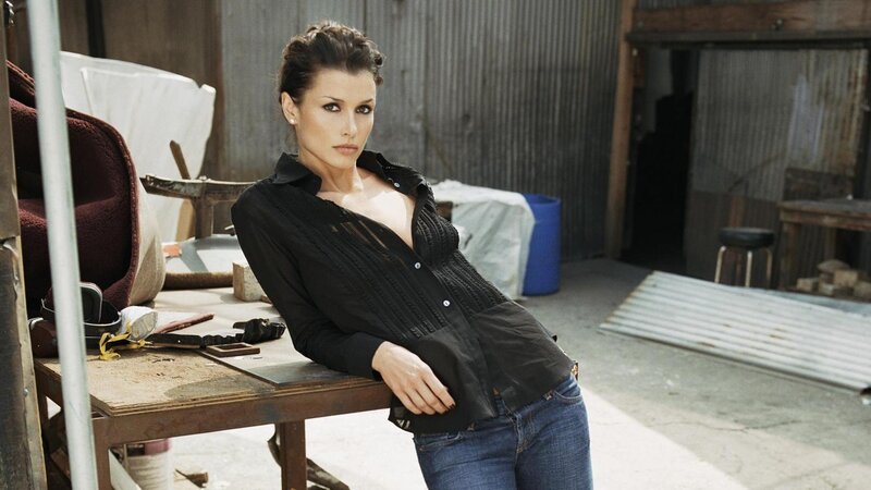 woman in black shirt leaning on table