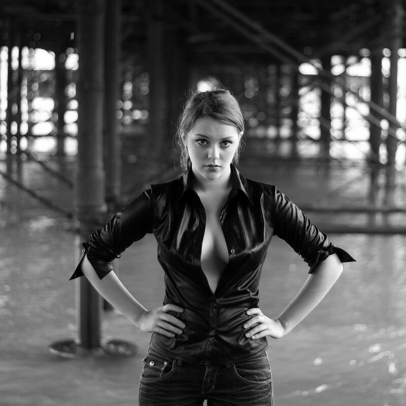 woman in black shirt under pier