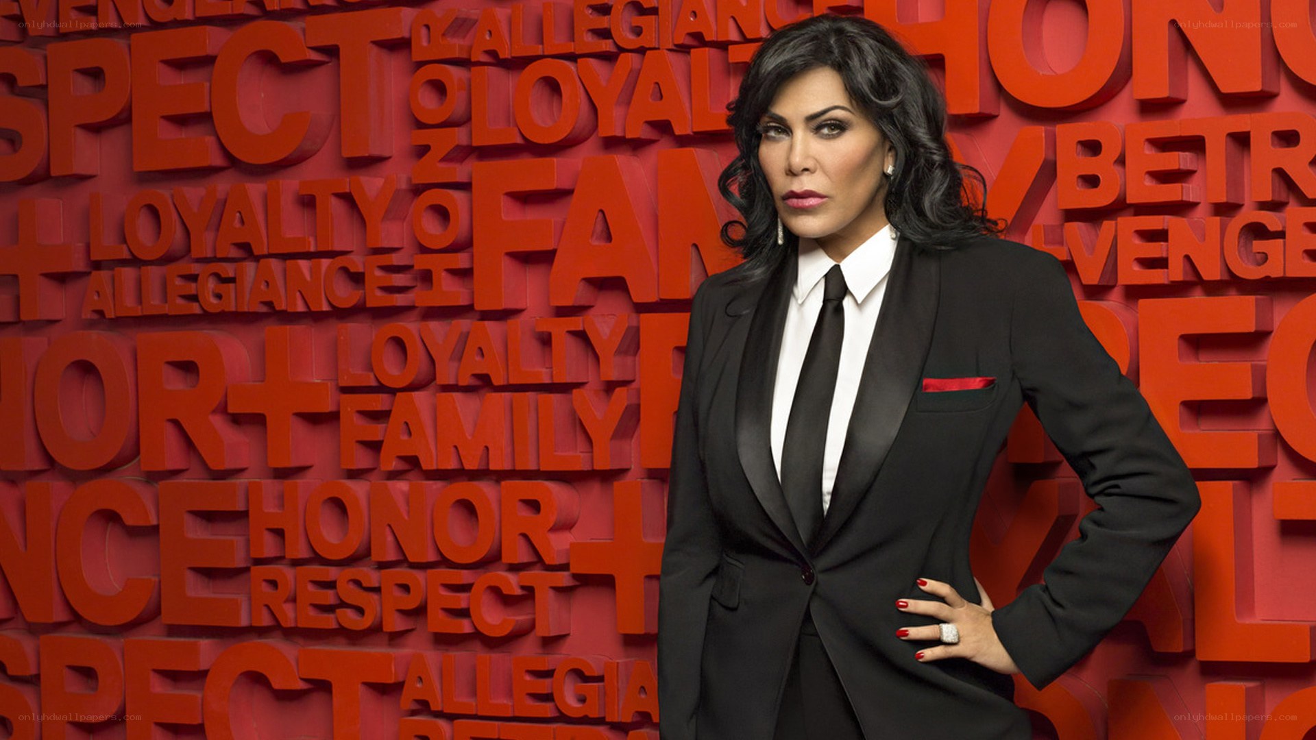 woman in black suit against red wall