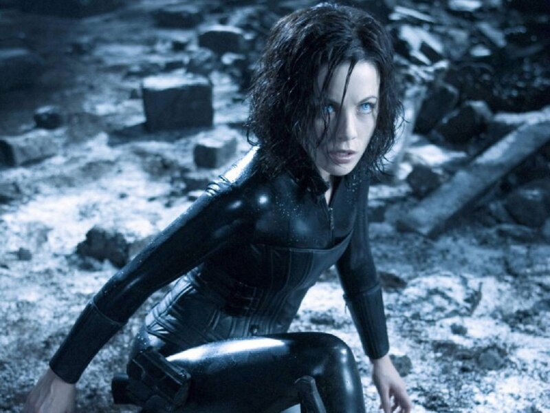 Woman in black suit crouching