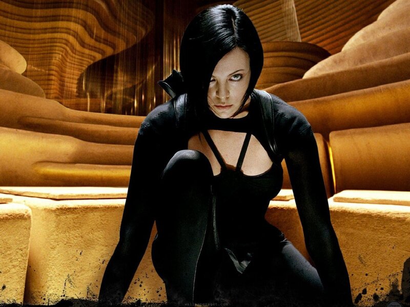 woman in black suit crouching