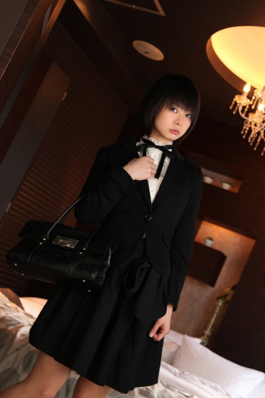 woman in black suit holding bag