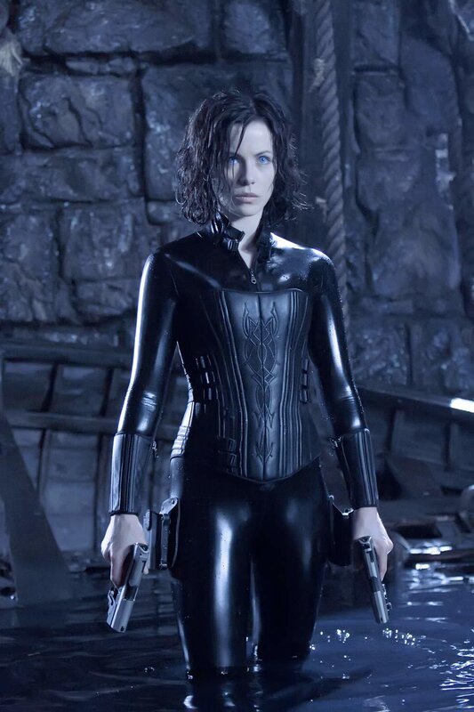woman in black suit holding guns