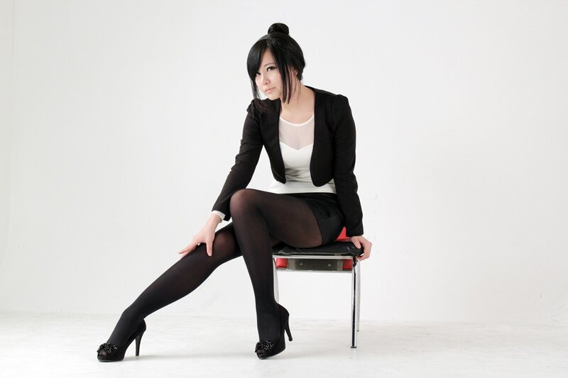 Woman in Black Suit — Neutral, Photograph, Chair
