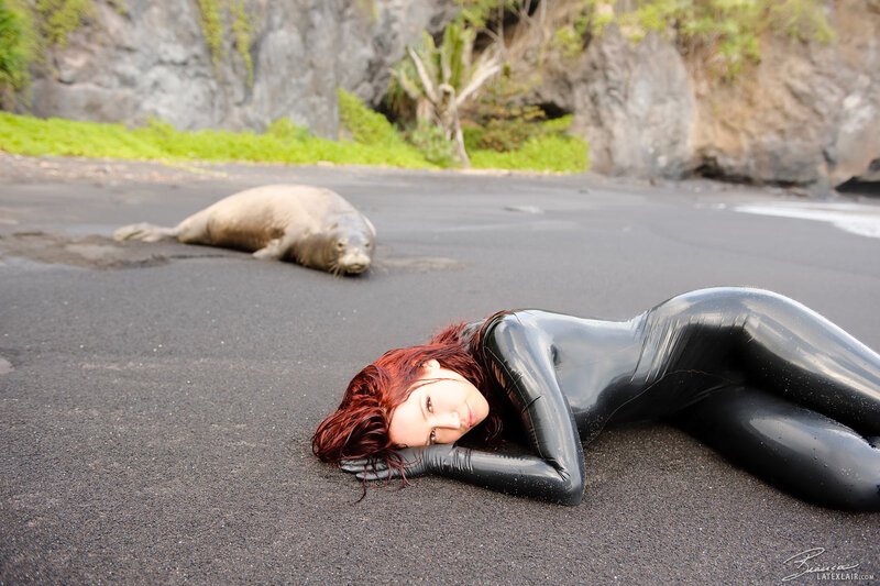 Woman in black suit on beach