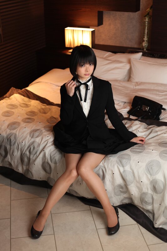 woman in black suit on bed