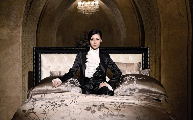woman in black suit on bed
