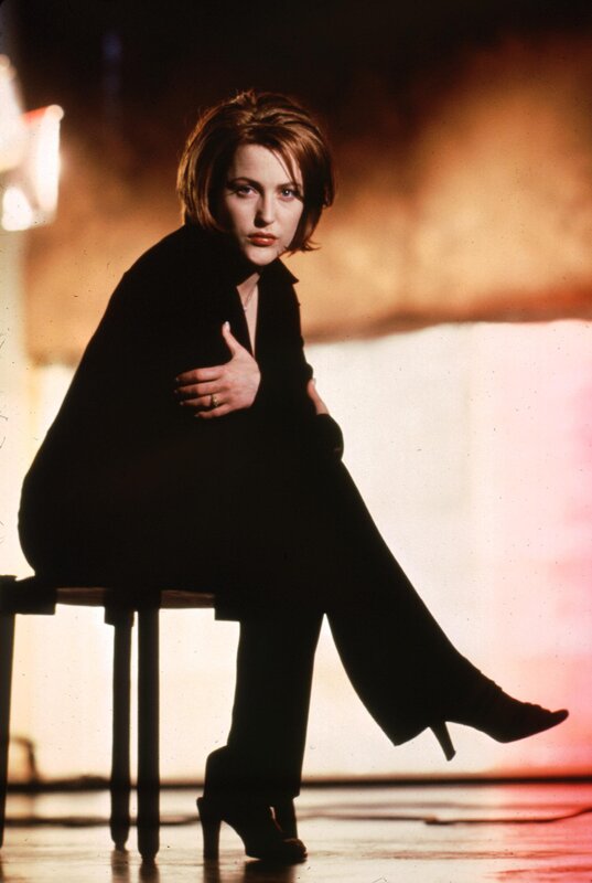 woman in black suit sitting