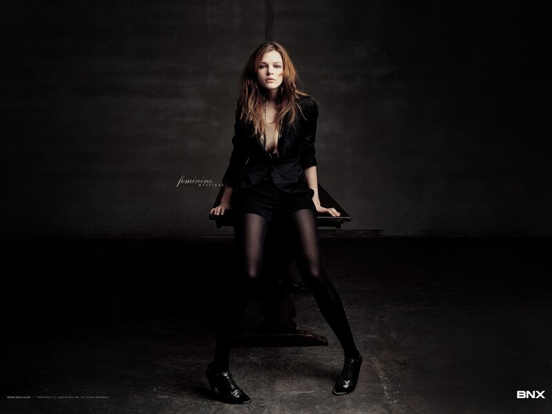 woman in black suit sitting
