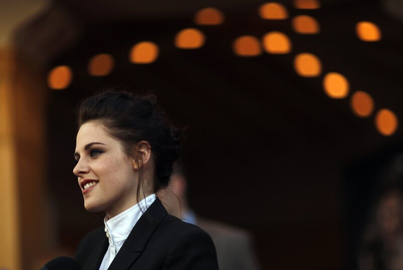 woman in black suit smiling
