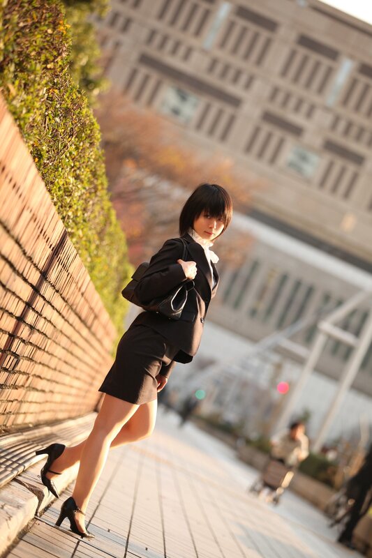 woman in black suit walking