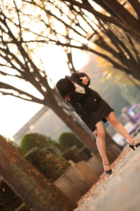 woman in black suit walking