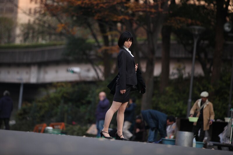 woman in black suit walking